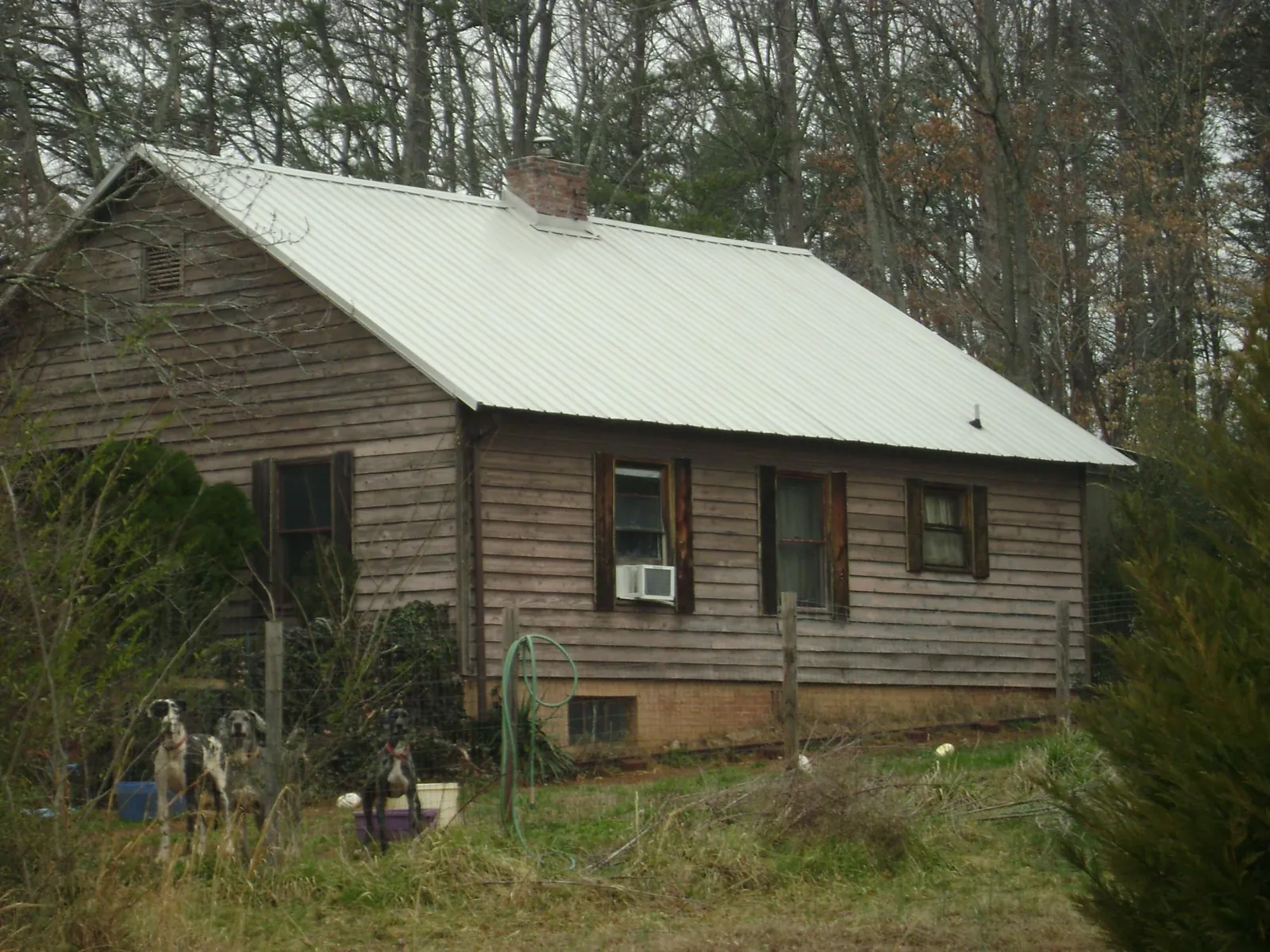 White metal roof on an old wood sided farmhouse, from a Metal Roof Installation job in Varysburg